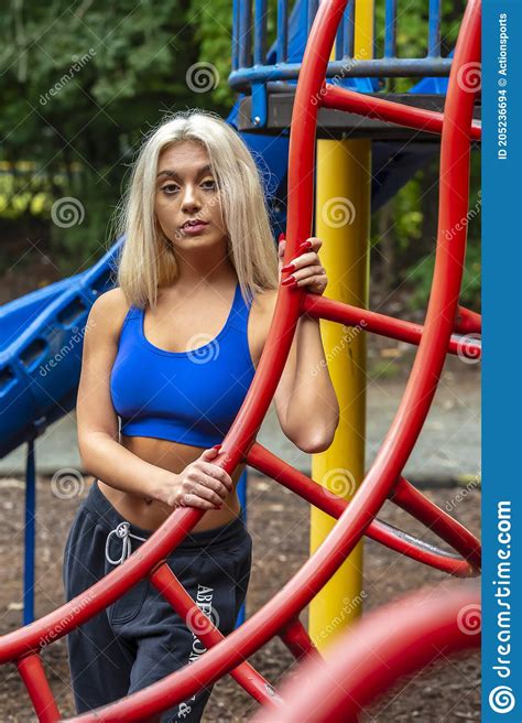 A Young Lovely Blonde Model Works Out Outdoors While Enjoying A Summers