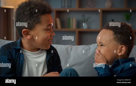 Two Little Boys Friendly Talking Laughing At Home Ethnic African