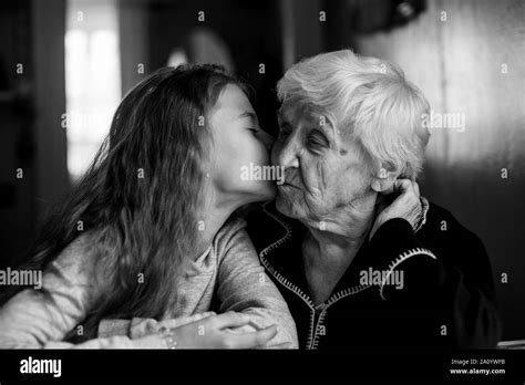 Vieille Femme grand mère baiser avec sa petite fille Photo en noir et