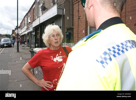 A Police Community Support Officer Pcso And Old Woman On Duty In Coventry United Kingdom Stock