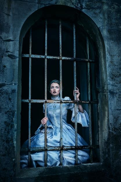 premium photo woman in victorian dress imprisoned in a dungeon