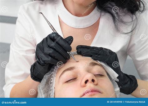 Mechanical Facial Cleansing With Metal Device At The Beautician Clinic
