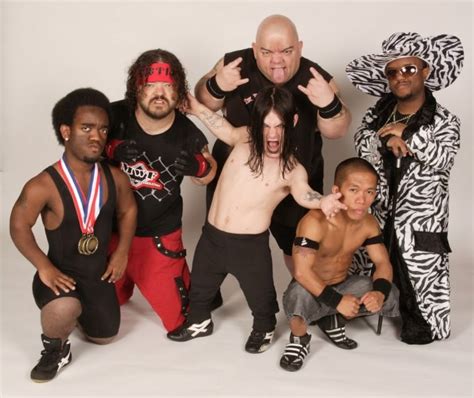 A Group Of Wrestlers Posing For A Photo