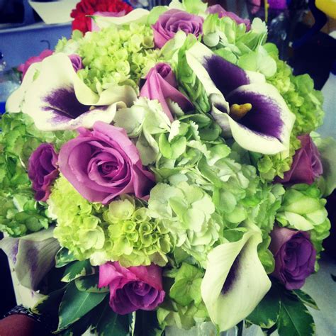 picasso mini callas purple roses lisiathus and miniature green hydrangeas in a clutch wedding