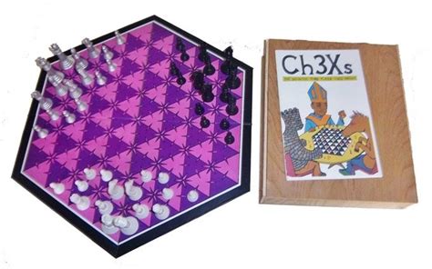 The Board Game Ch3xs Is Next To Its Original Box And Its Contents