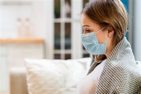free photo woman wearing surgical face mask indoors