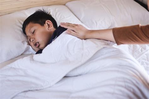 Premium Photo Close Up Hand Of Mother Gently Wakes Up Her Son Asian