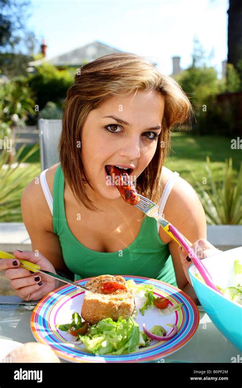 Young Woman Eating Sausage Model Released Stock Photo Alamy