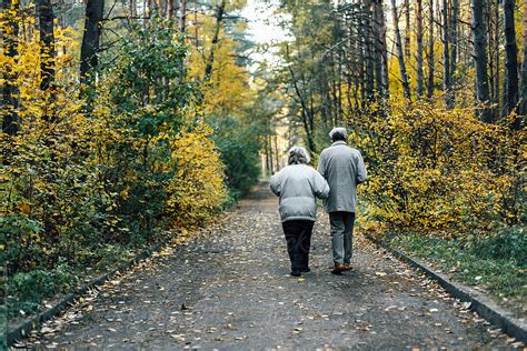Unrecognizable Senior Couple Walking In Nature By Stocksy Contributor Alina Hvostikova Stocksy