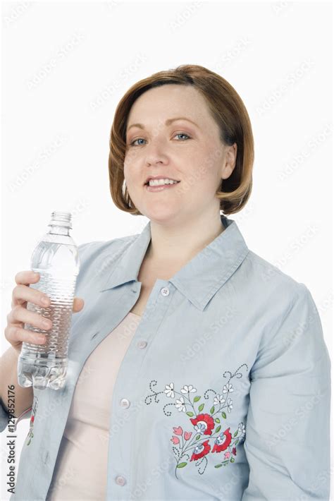 Portrait Of Woman Holding Water Bottle Isolated Over White Background