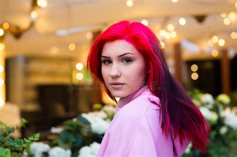 Beautiful Red Haired Girl In The Evening On A Lighted City Street