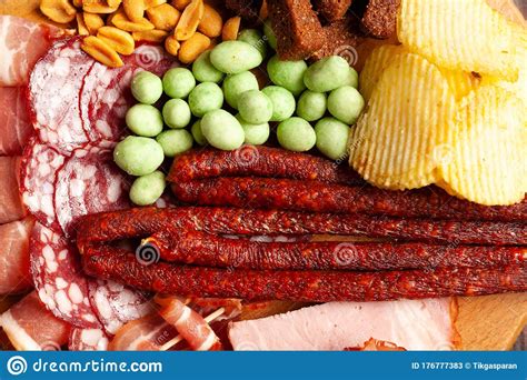 Assorted Beer Snacks On A Wooden Table With Copy Space Sausage Ham