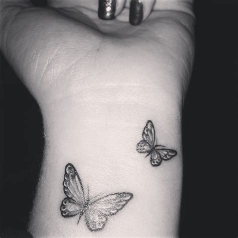 Simple butterfly memorial tattoo on foot. Butterfly Tattoo on Wrist (With images) | Butterfly wrist tattoo, Black butterfly tattoo ...