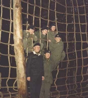 A Group Of Babe Men Standing Next To Each Other In Front Of A Goal Net