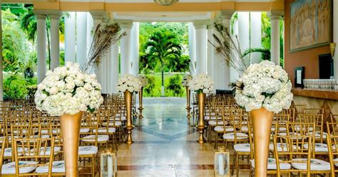 Wedding Ceremony Setup With Gold Chairs And White Flowers