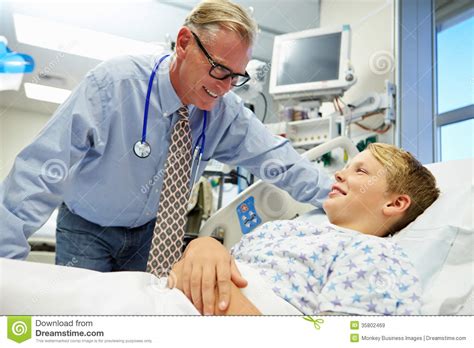 Boy Talking To Male Consultant In Emergency Room Stock Image Image Of