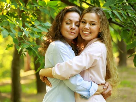 Mature Mother And Adult Daughter Hugging In The Park On A Summer Day Stock Image Image Of