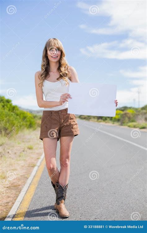 Smiling Woman Holding Sign While Hitchhiking Stock Image Image Of Blonde Casual 33188881