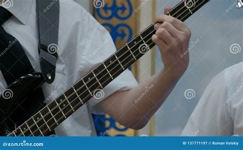 The Fingers Of The Teenager Clamp The Strings On The Frets Of The