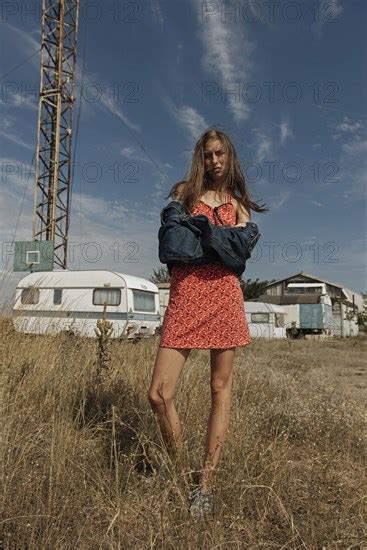 Serious Caucasian Woman Standing In Field Near Trailers Photo12 Tetra Images Ivan Ozerov