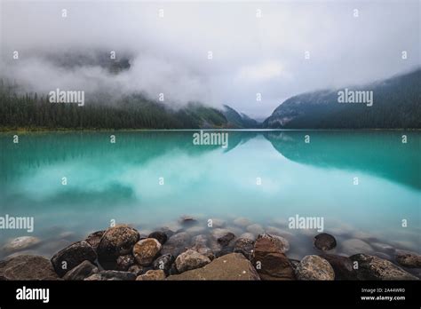 Turquoise Colored Lake Louise With Reflections Of The Surrounding