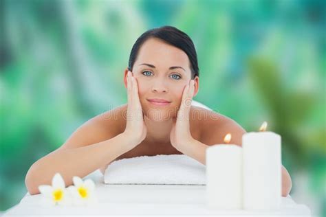 Beautiful Brunette Relaxing On Massage Table Smiling At Camera Stock Photo Image Of Care