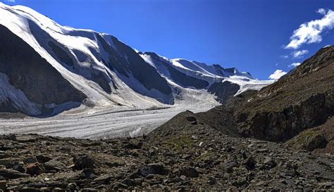 Beautiful Glacier With Snow Capped Mountain In Sunny Day With Blue Sky