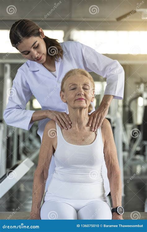 Physiotherapist Helping Old Senior Woman In Physical Center Elderly Health Lifestyle Concept