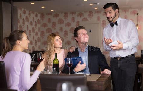 Young Waiter Taking Order In Restaurant Stock Photo Image Of Guests