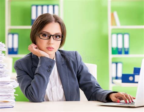 Young Female Employee Very Busy With Ongoing Paperwork Stock Image