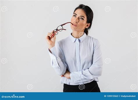 image of beautiful secretary woman wearing eyeglasses standing in the office isolated over
