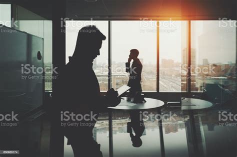 Silhouette Of Two Businessmen In Office Interior Stock Photo Download