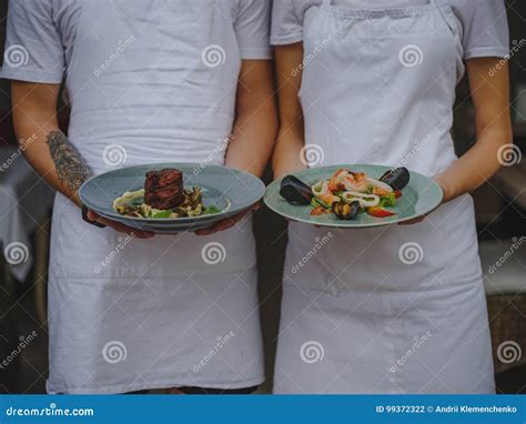 Couple Of Waiters Holding Plates Waiter And Waitress Serving Food On A