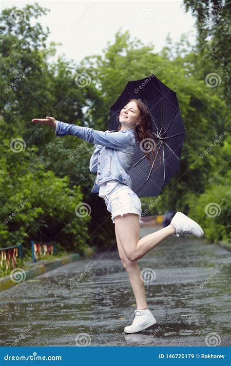 Cheerful Woman With An Umbrella Walking In The Rain Stock Image Image