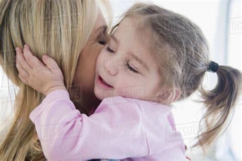 Close Up Of Caucasian Mother Kissing Daughter Stock Photo Dissolve