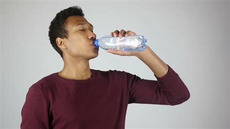 Profile Close Up Of A Man Taking A Refreshing Drink From A
