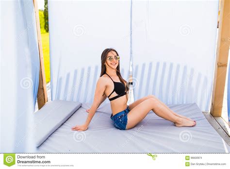 Woman Relaxing In Chaise Lounge At The Poolside Summer Time Stock