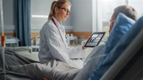 Hospital Ward Friendly Female Doctor Talks To Sick Male Patient