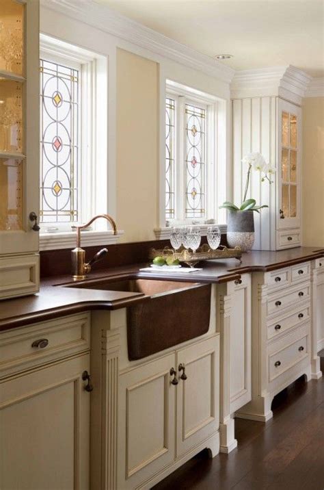 If the sink is an undermount type, unfasten the screws holding it to the countertop. White cabinets, Dark countertop, Wood floor, copper sink ...