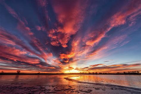 Sunrise Over A Half Frozen Lake Photograph By Tony Hake