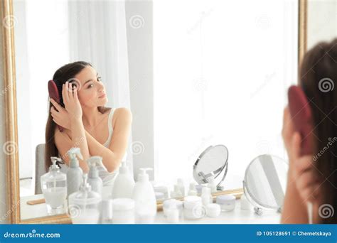 Young Woman Brushing Hair In Front Of Mirror Stock Image Image Of Beautiful Health 105128691