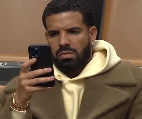 a forlorn shot of drake scrolling his phone at the raptors game have fans predicting ‘take care 2