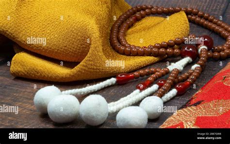 japa mala buddhist or hindu prayer beads with yellow mustard fabric element for meditation