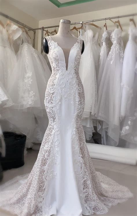 Alluring Deep V Neck Sleeveless White Mermaid Wedding Dress With Lace
