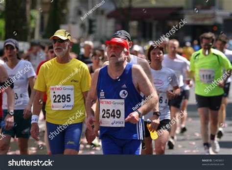 Two Senior Marathon Runners Trying To Keep The Pace During The