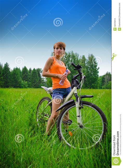 Young Woman On Bike Drinking Water Stock Photo Image Of