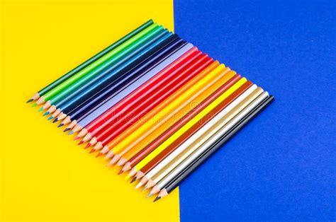 Set Of Colored Pencils For Schoolboy On Bright Background Stock Photo