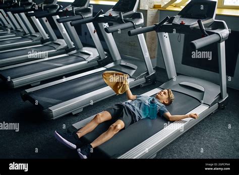 Tired Youngster Lying On Treadmill In Gym Running Machine Boy On