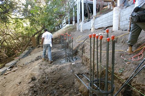 Exterior stonework) and a deep, signature front porch with tapered, square columns set upon heavy piers. High Quality Foundation Repair Contracting Services