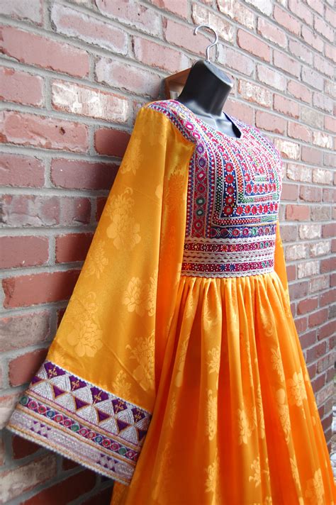 This Bright Yellow Afghani Dress Features A Long Pleated Skirt And